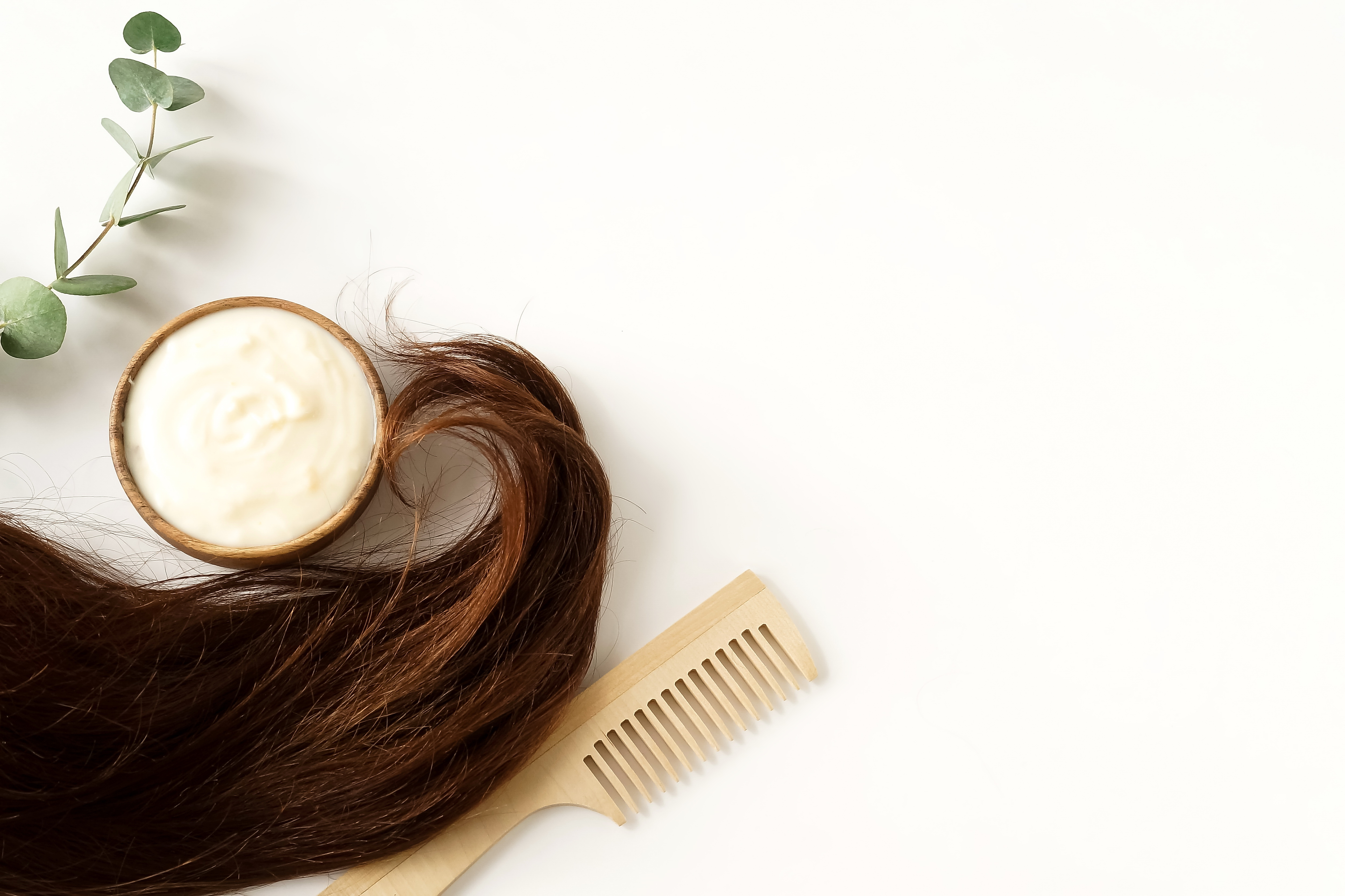Hair lay next to a hair mask and comb