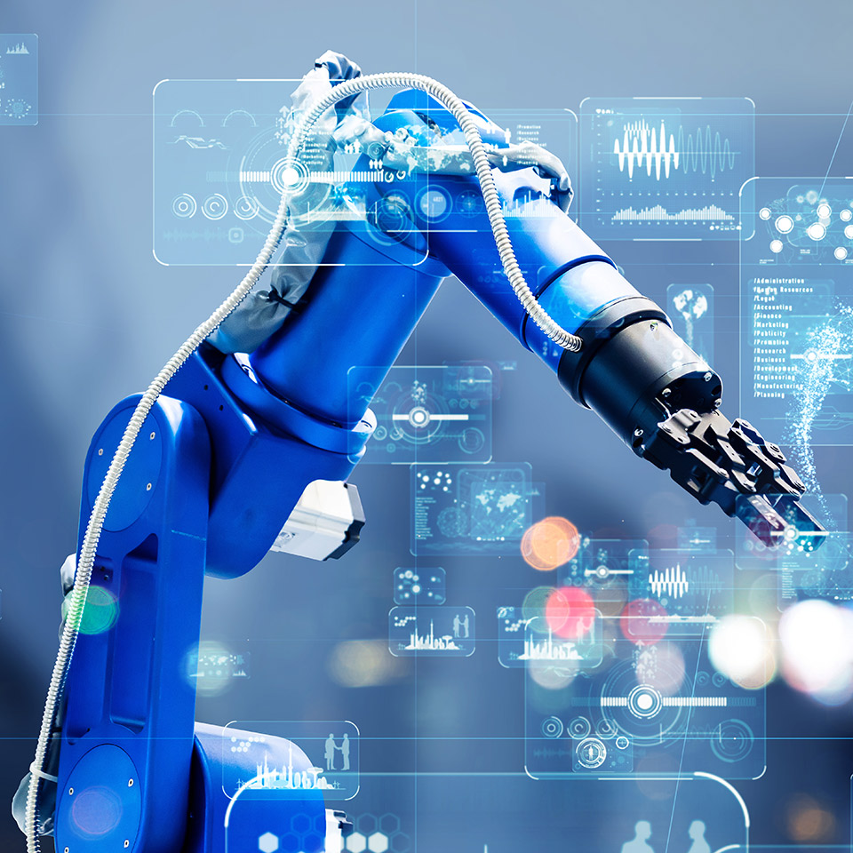 Industrial robot arm at work in front of a digital display