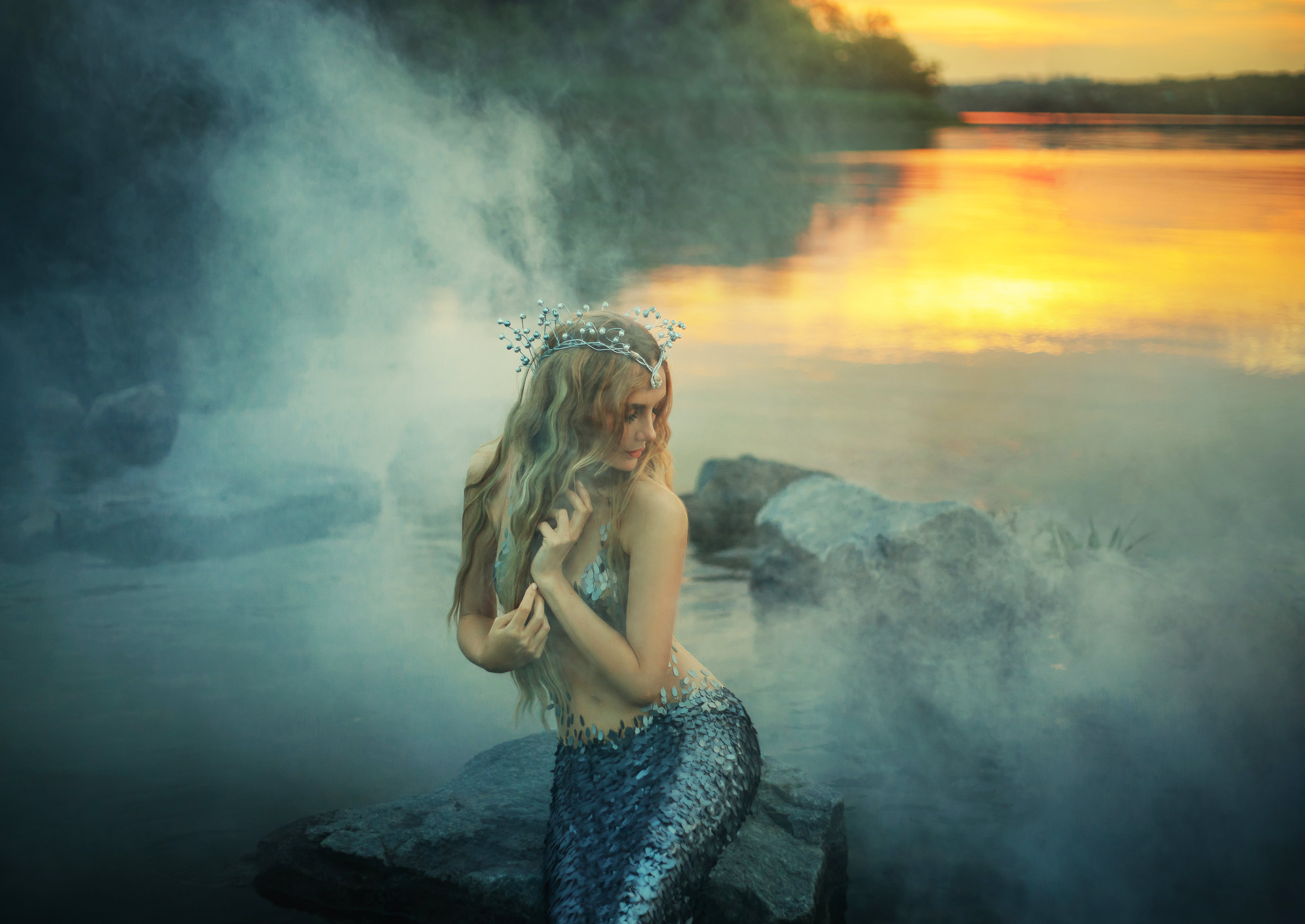 An image of a siren sitting on rocks