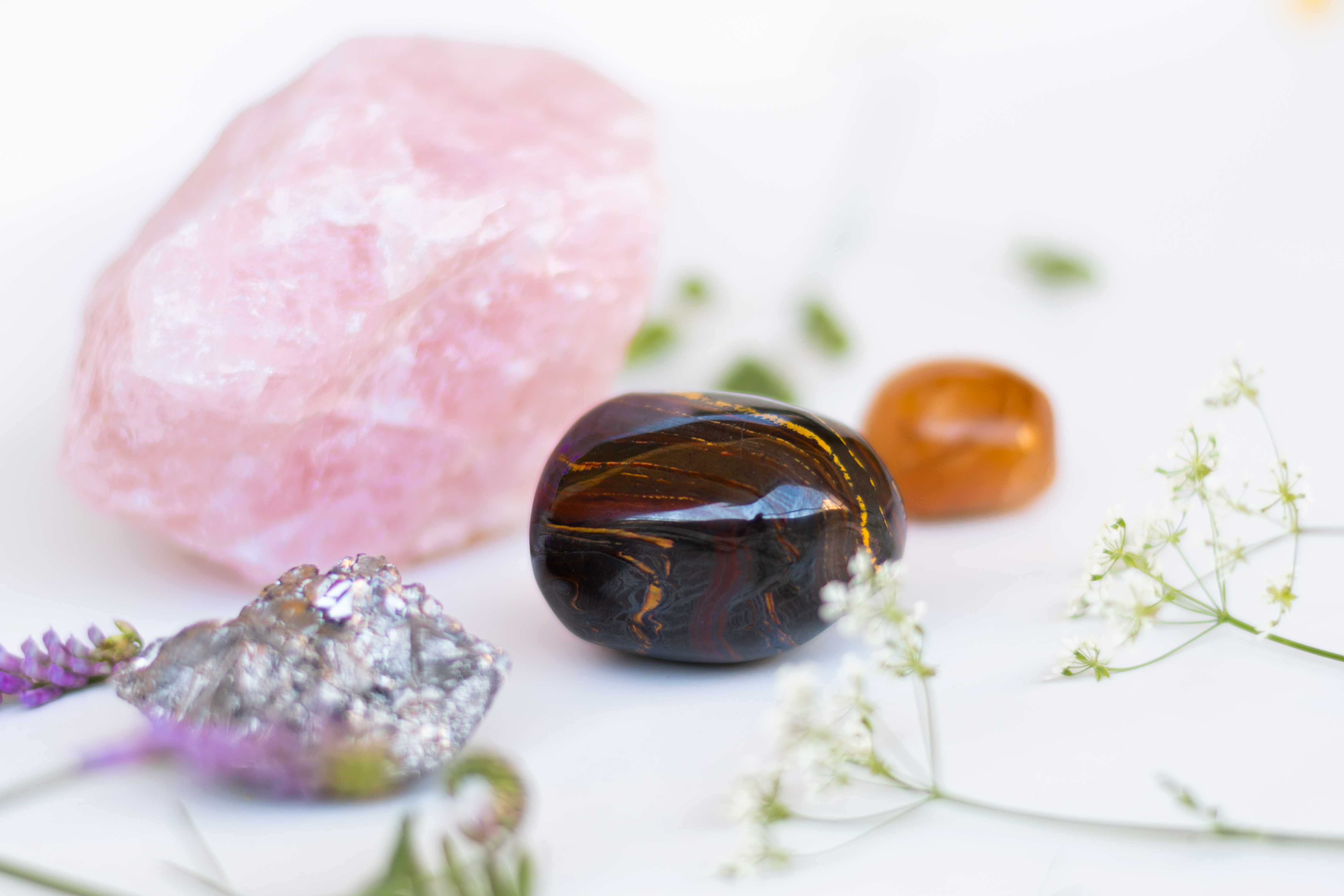 A Tiger's Eye crystal with other crystals including Rose Quartz