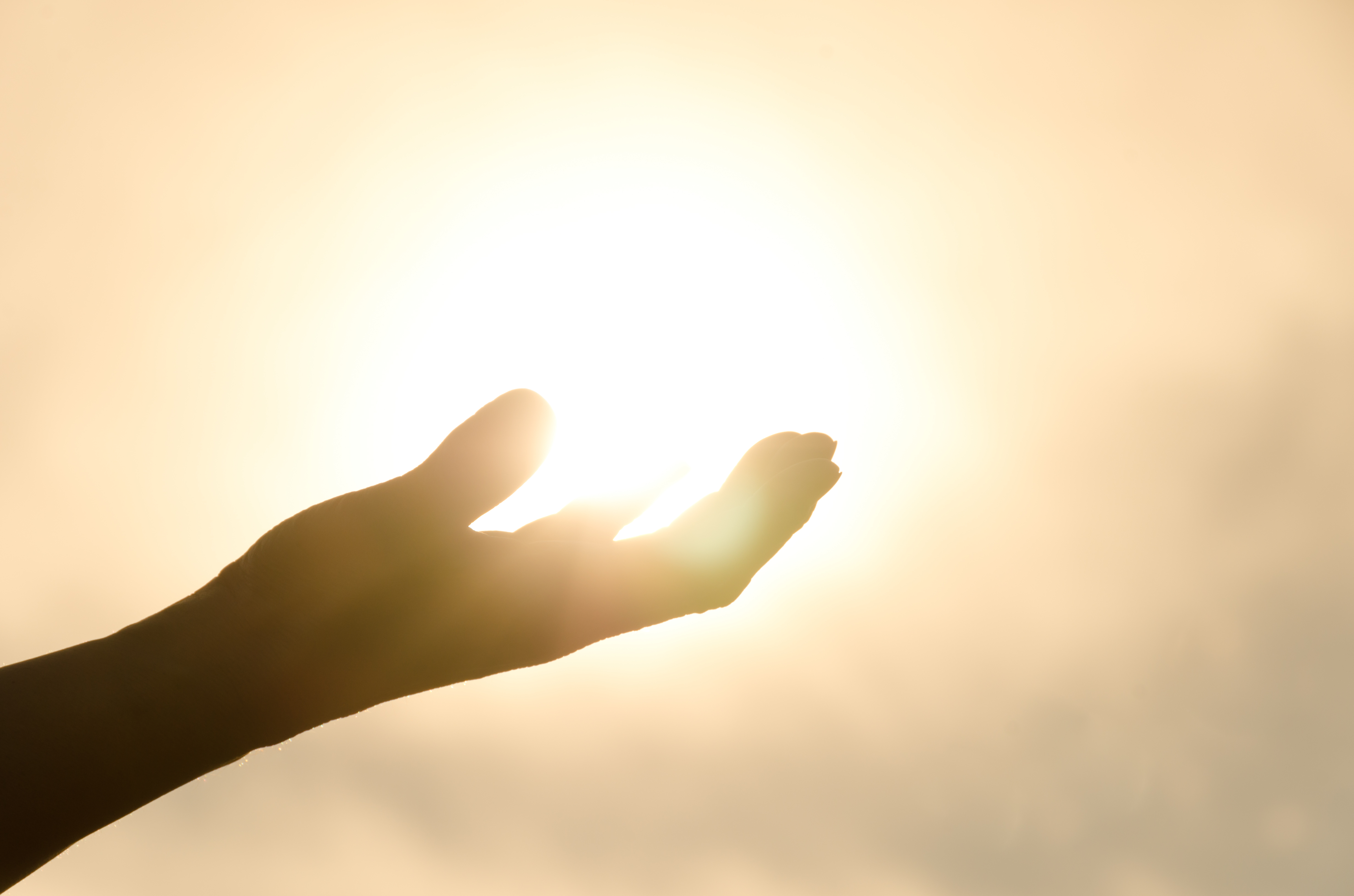 Meditation and spiritual practice, hand glowing in the sun