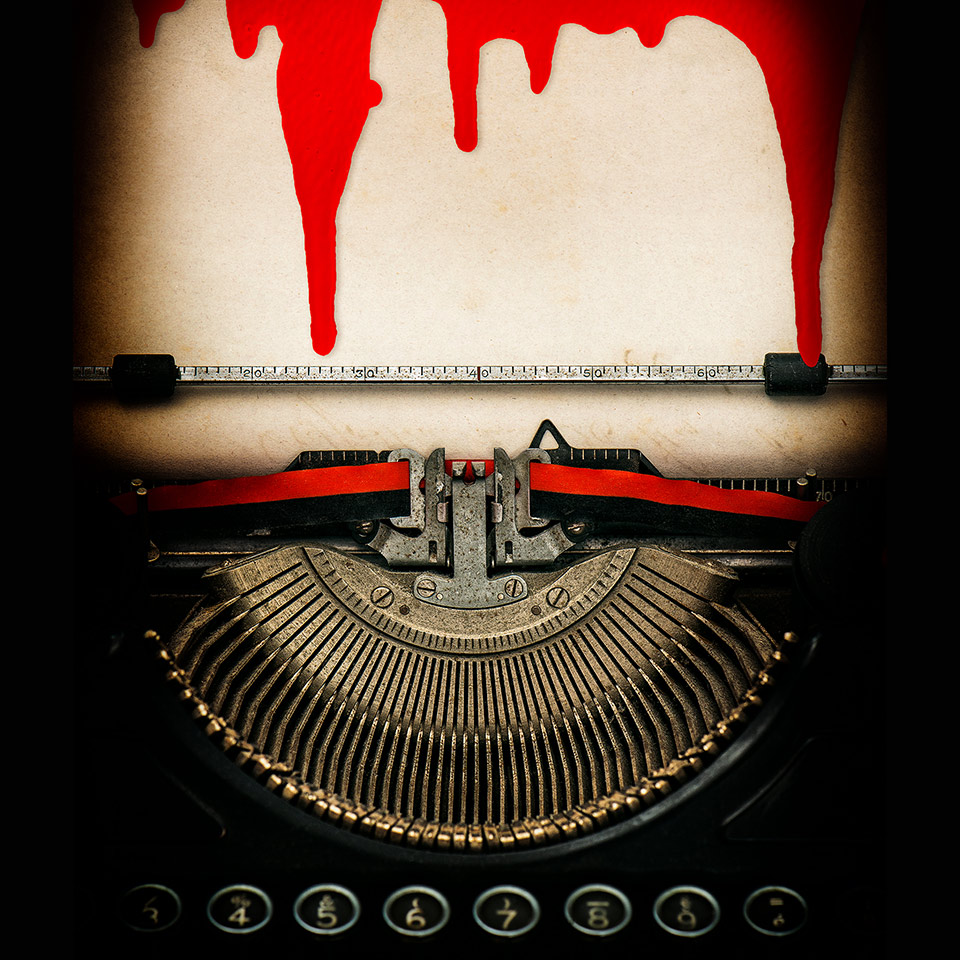 Antique typewriter with a sheet of paper dripping with blood