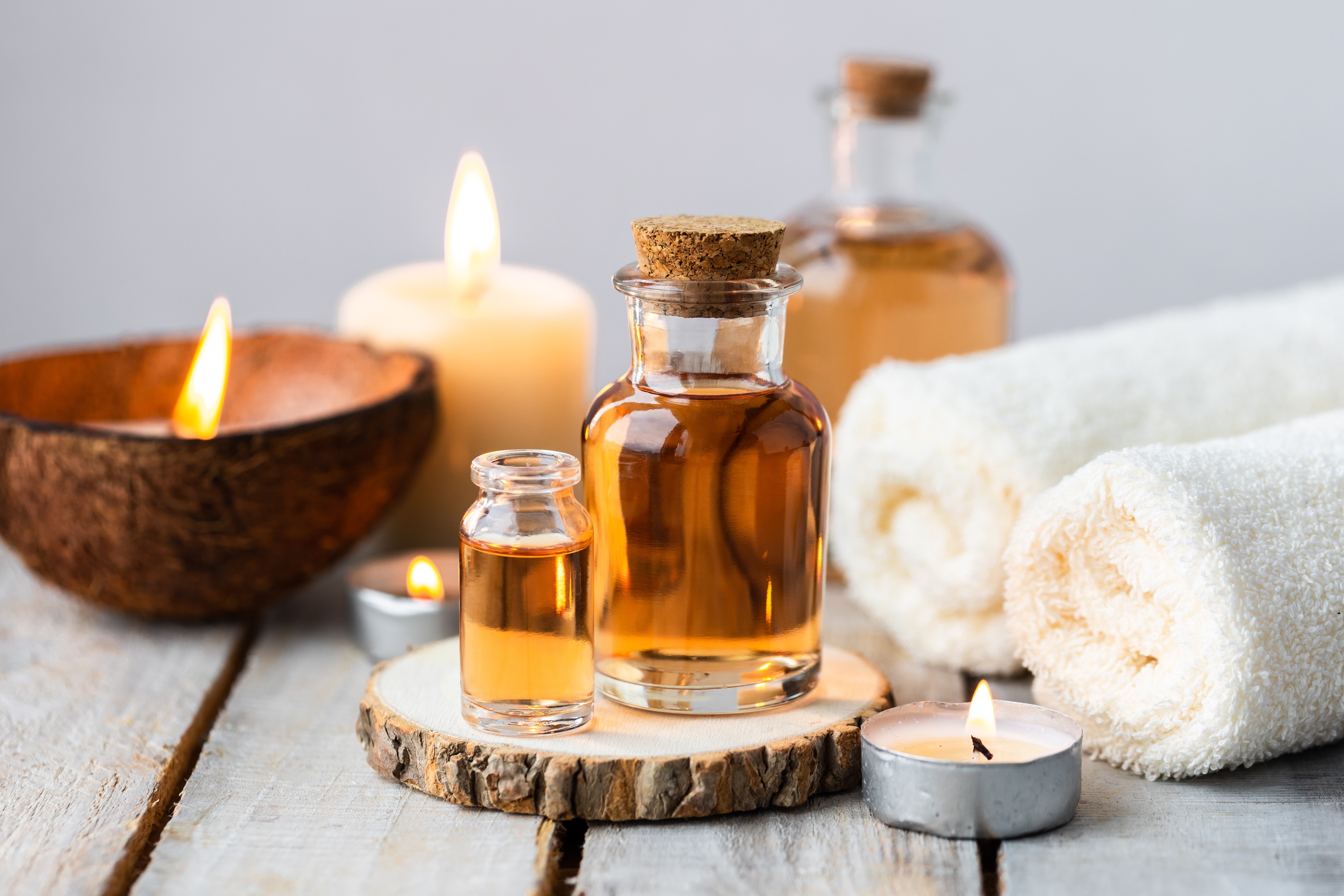 Massage oils with candles and coconut and towels