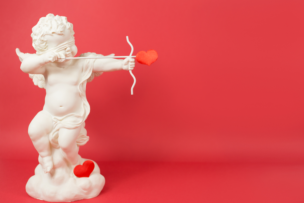 Statue of cupid shooting a heart