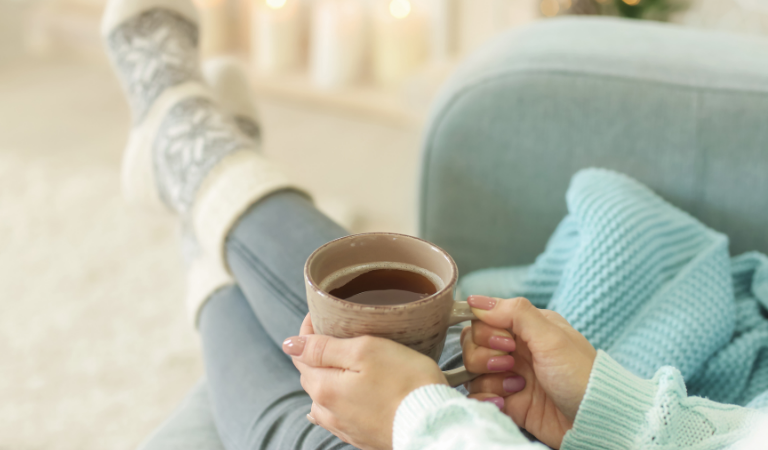person relaxing with mug of tea