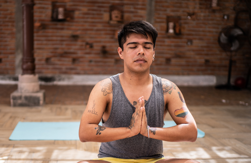 man meditating with palms together