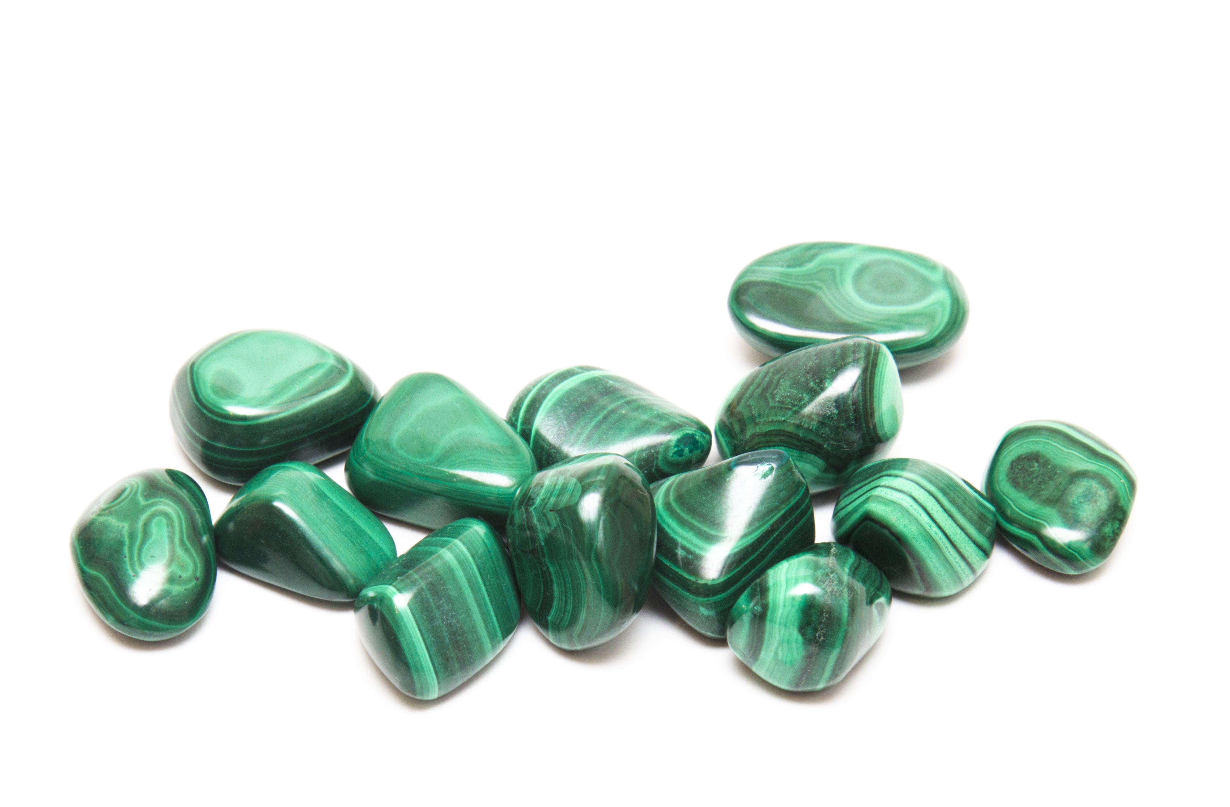 Lots of pieces of Malachite on a white background