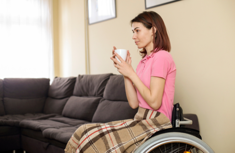 woman in wheelchair drinking tea