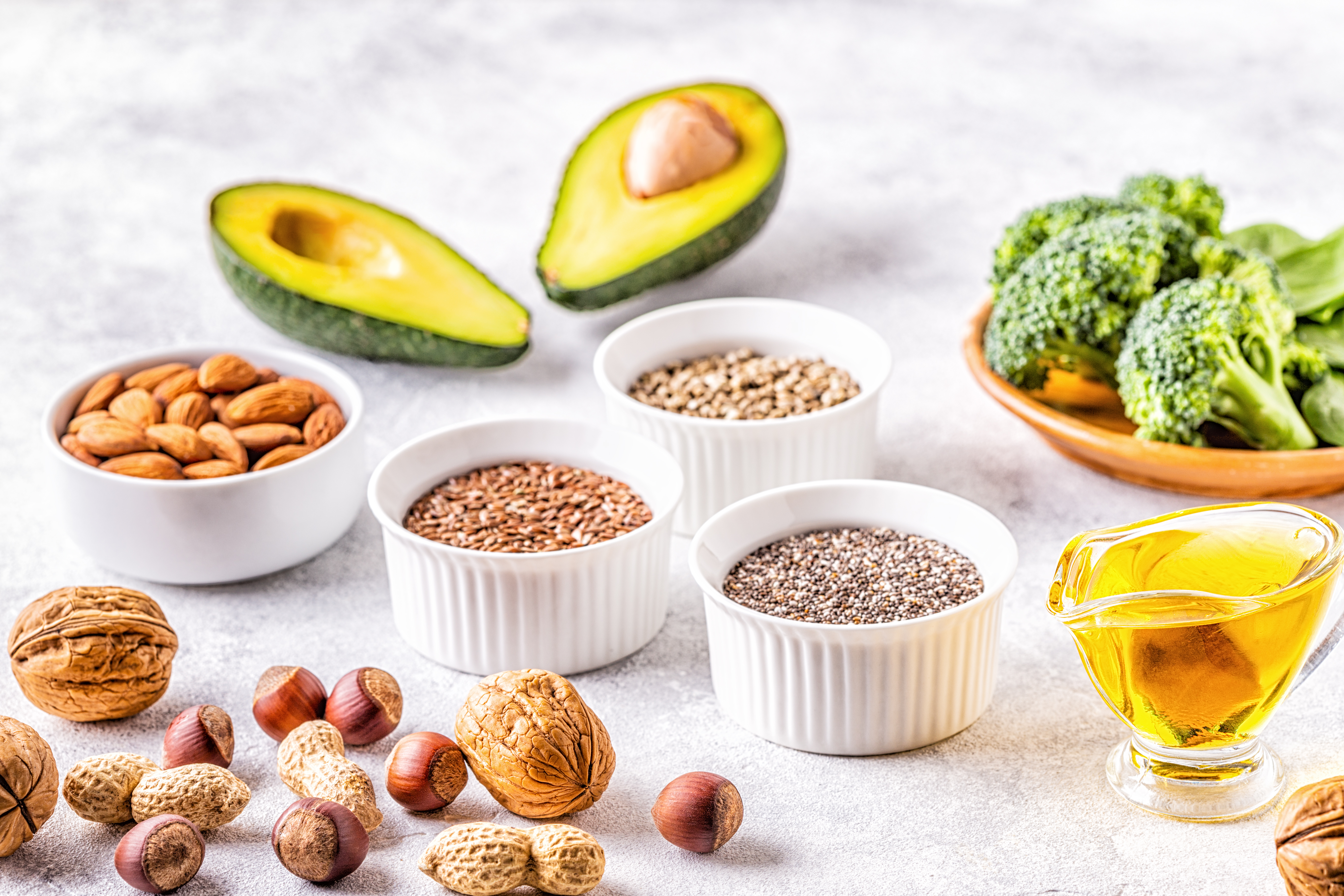 Vegan keto foods on a white table, healthy sources of omega 3