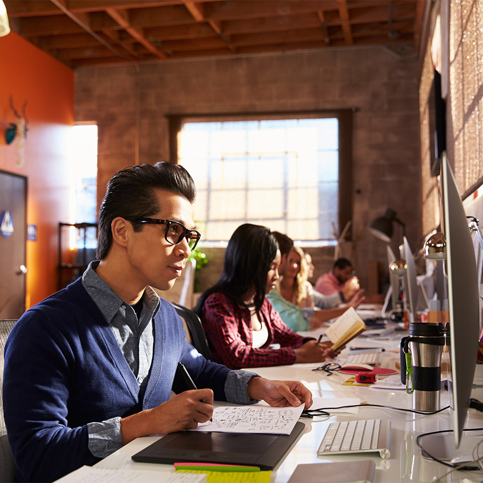 Graphic designers working at their desks in a modern office