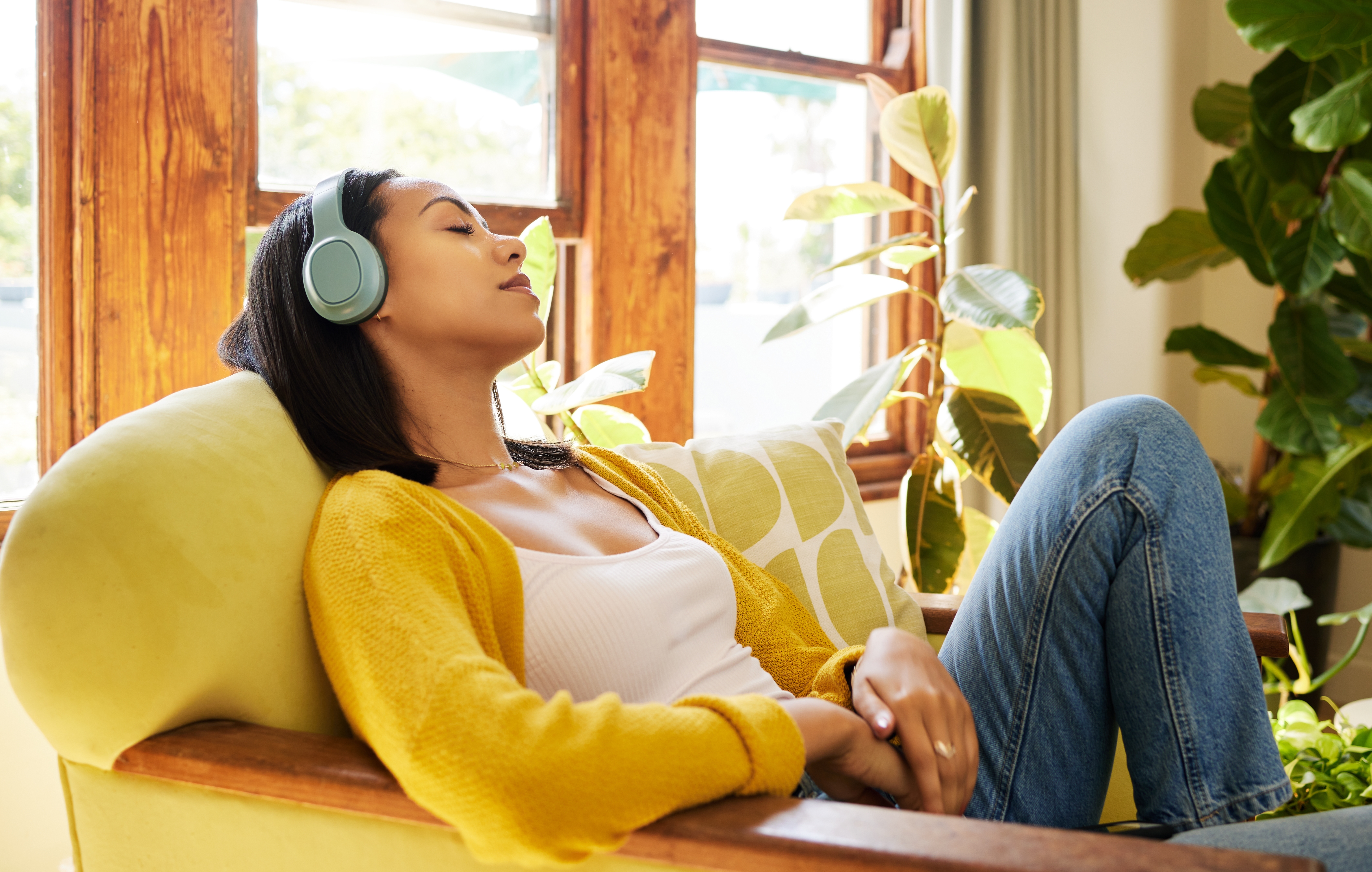 Woman relaxing with headphones on, self care