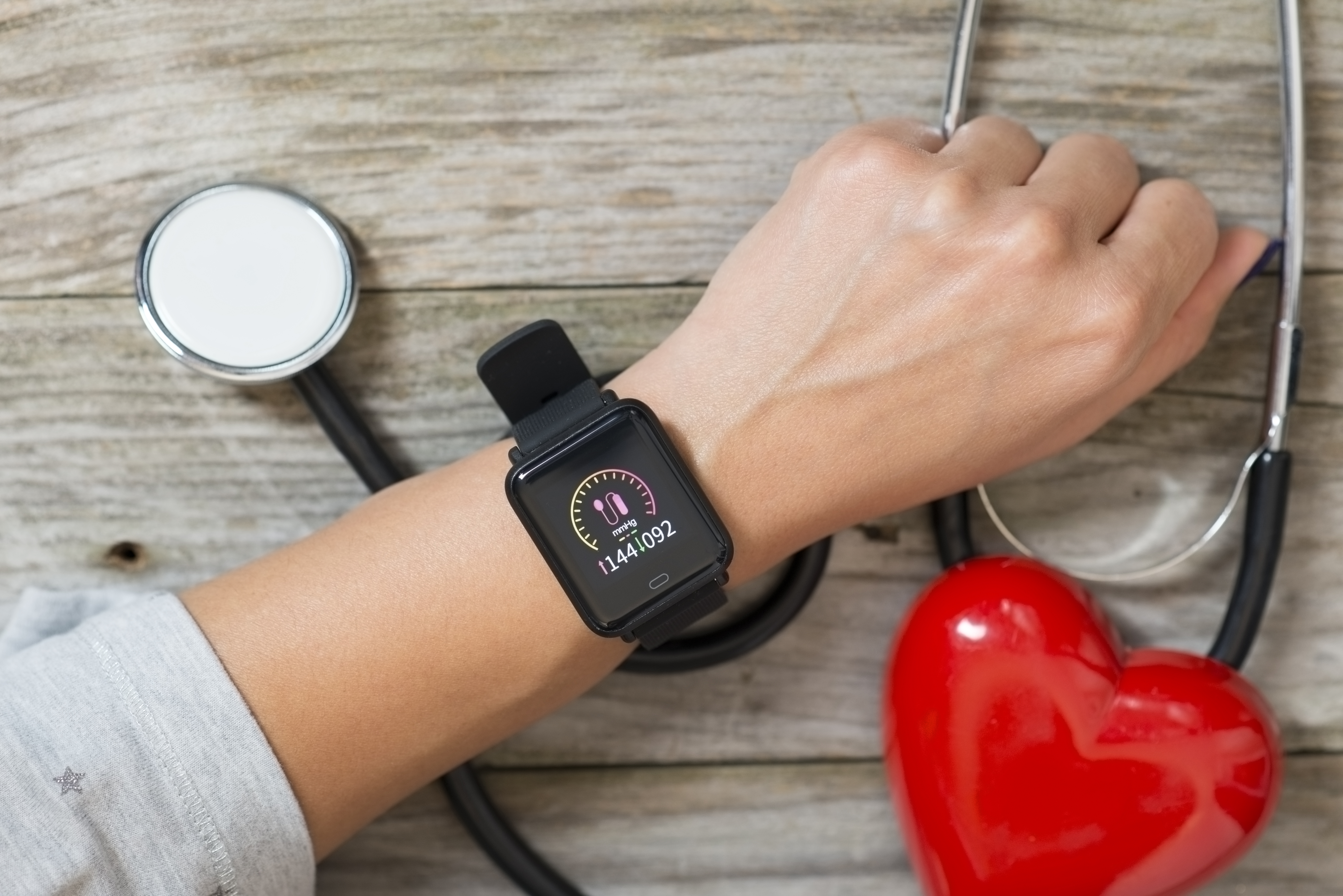 An image of an at home blood pressure monitor on someone's wrist