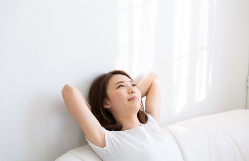 woman relaxing in white room