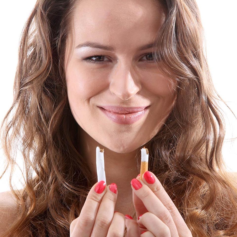 A smiling woman quitting smoking.