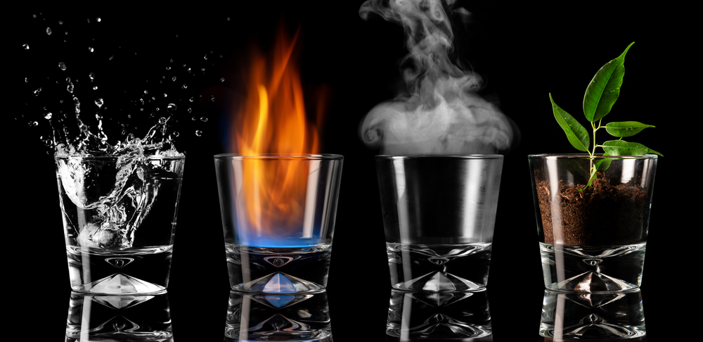 Four shot glasses with each of the elements - water, fire, air and earth - inside