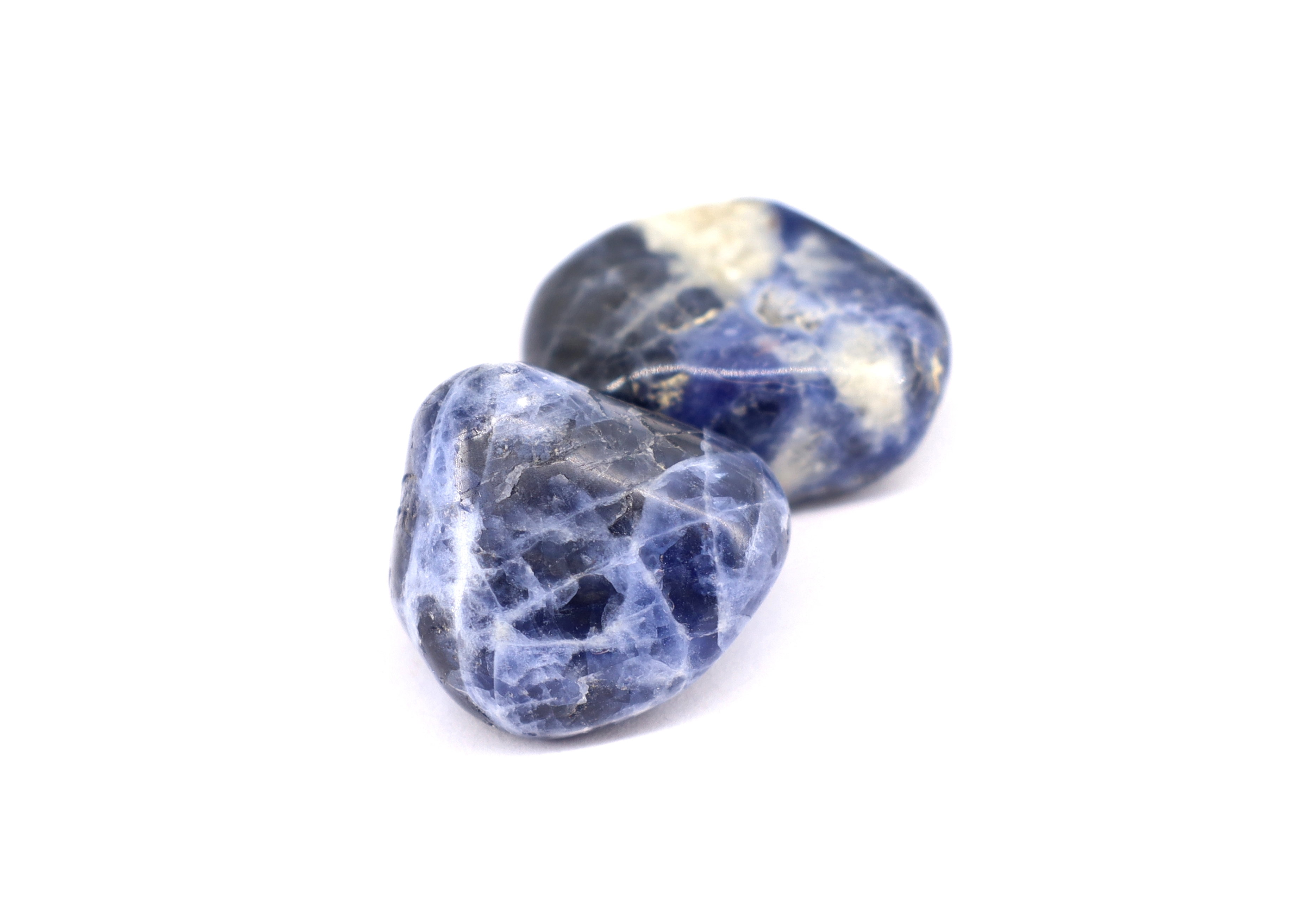 Two pieces of Sodalite on a white background