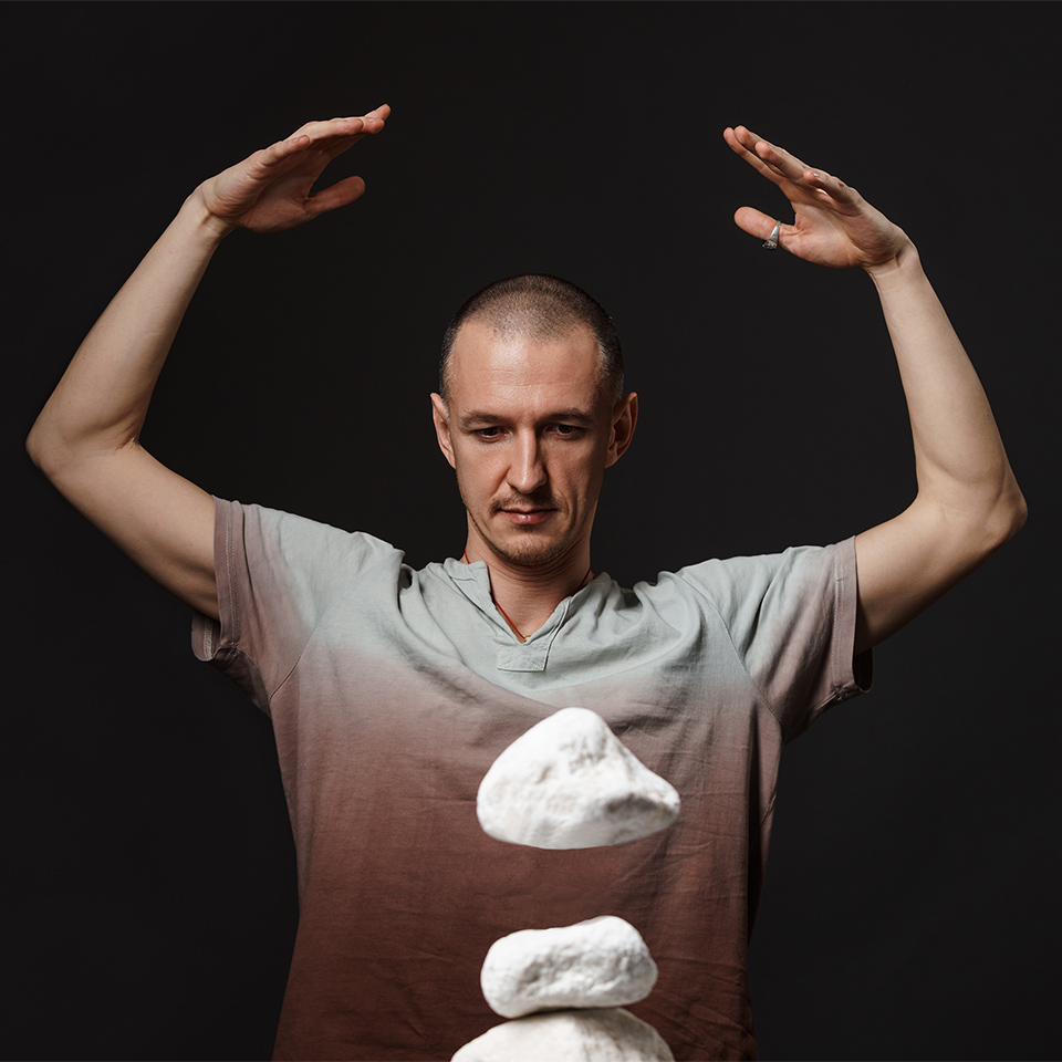 A man making a stone levitate with telekinesis