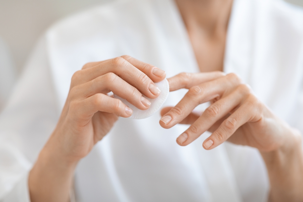 Woman cleaning nails, at home natural nail care