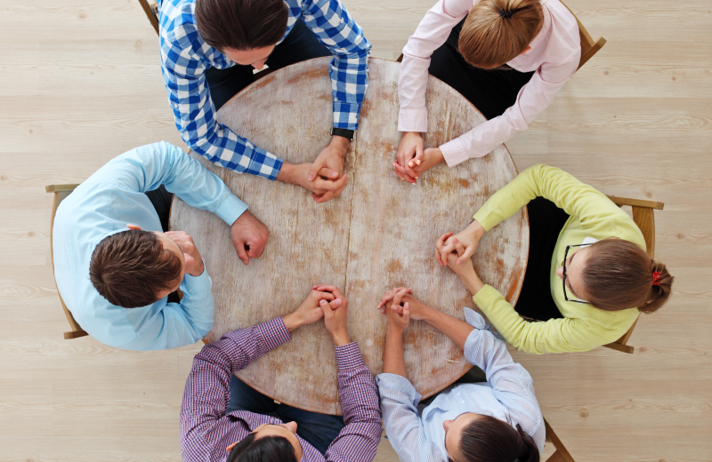 People meeting around a circular table.