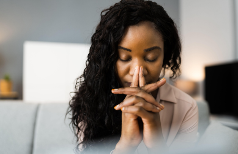 woman praying in home