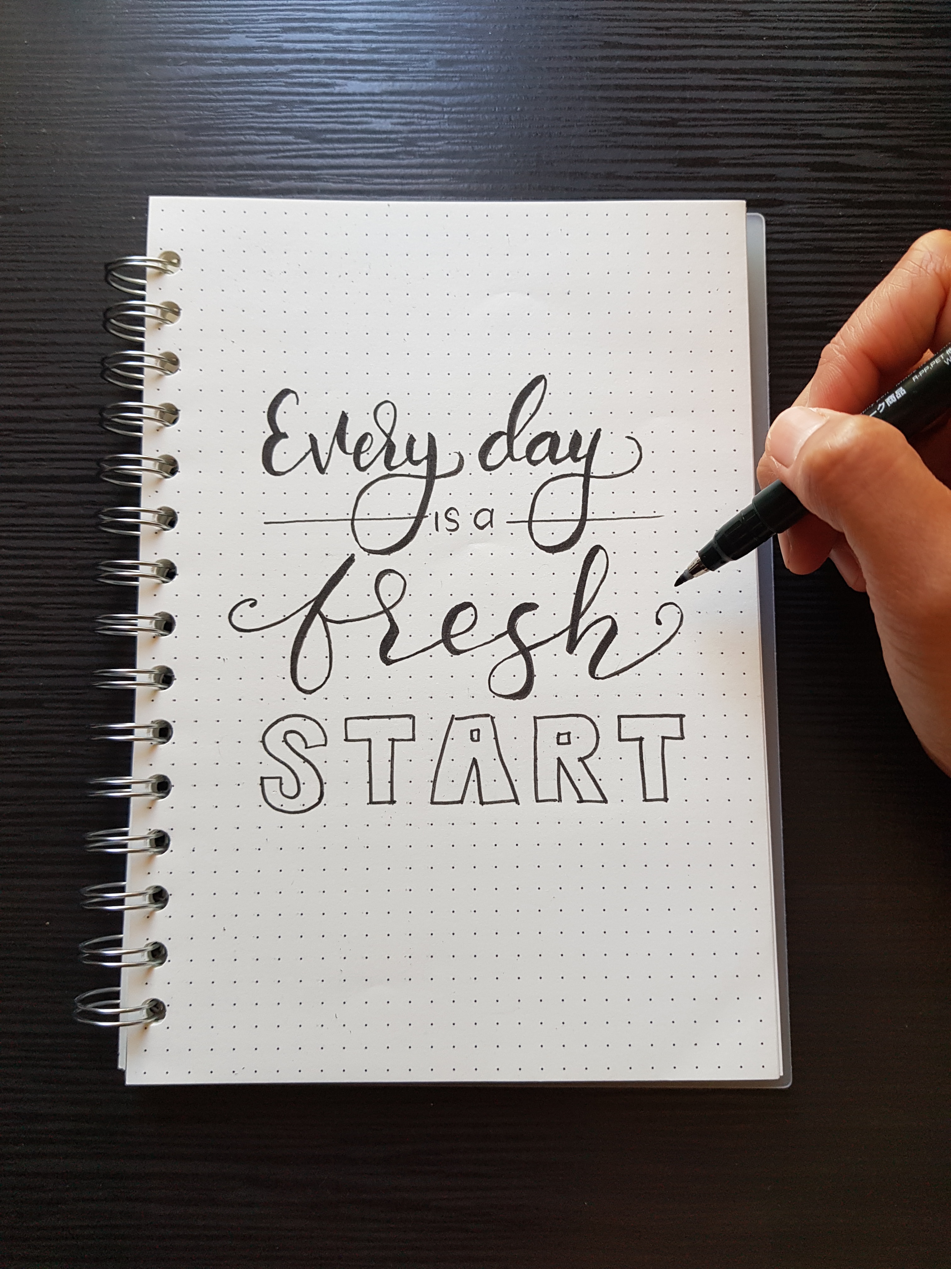 A notebook that reads "every day is a fresh start".