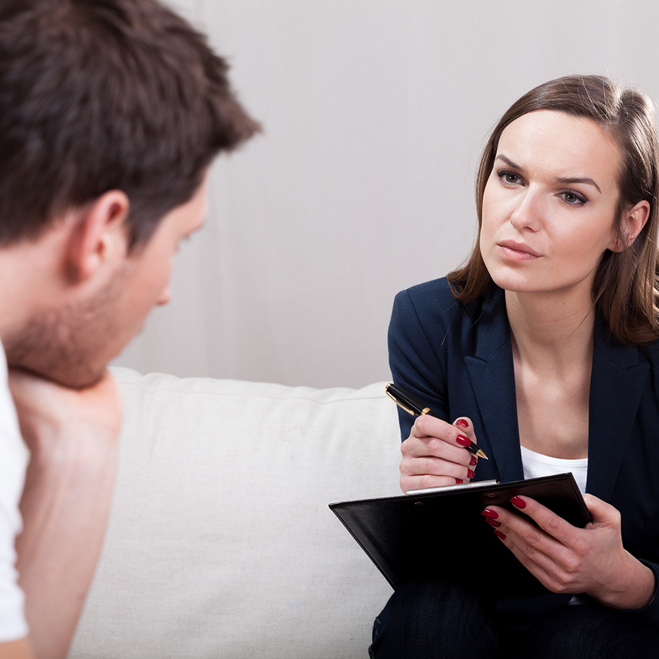 A woman guiding a man through a Gestalt Therapy session