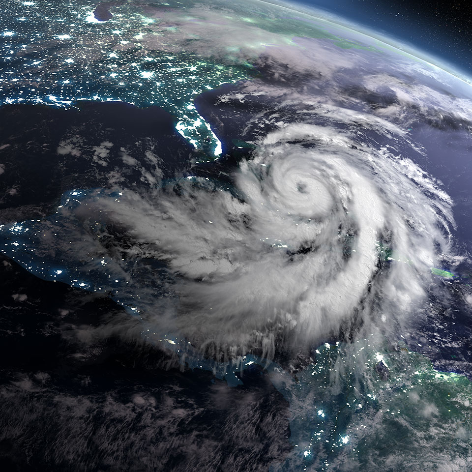 Earth at night from orbit with city lights and a huge hurricane near Florida, USA