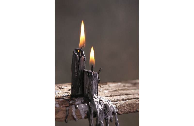 Black candle dripping wax