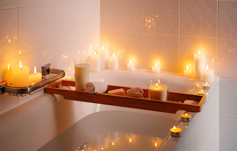 A bath with candles, epsom salts and oils
