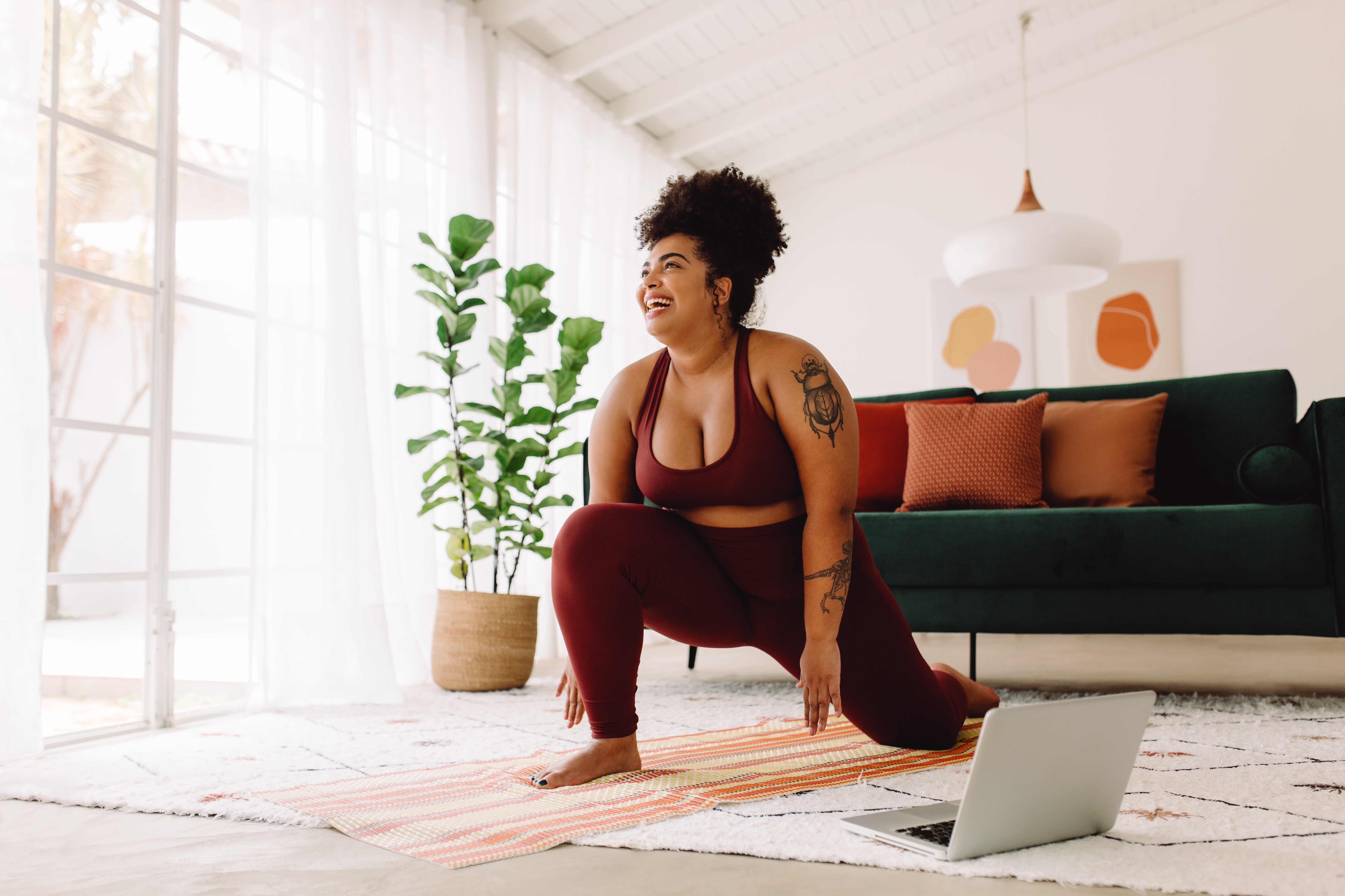 Plus-sized woman doing home workout in gym gear