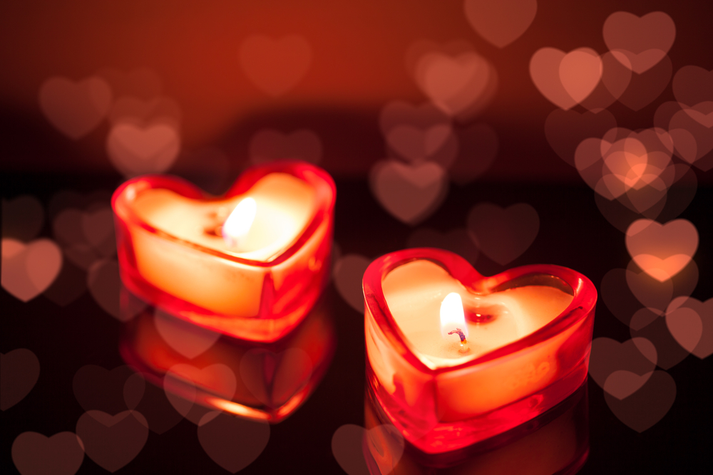 Two heart shaped candles lit