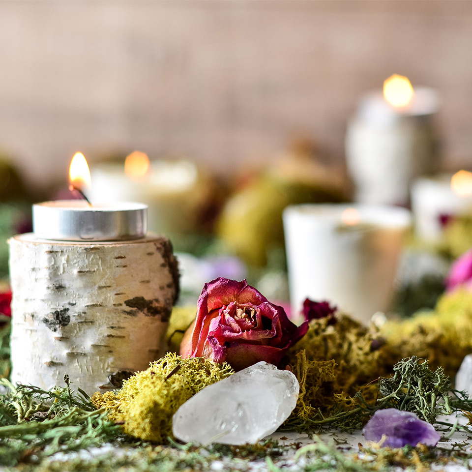 Candles and crystals laid out for a priestess ritual