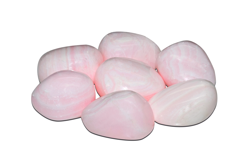 Multiple pieces of Pink Calcite on a white background