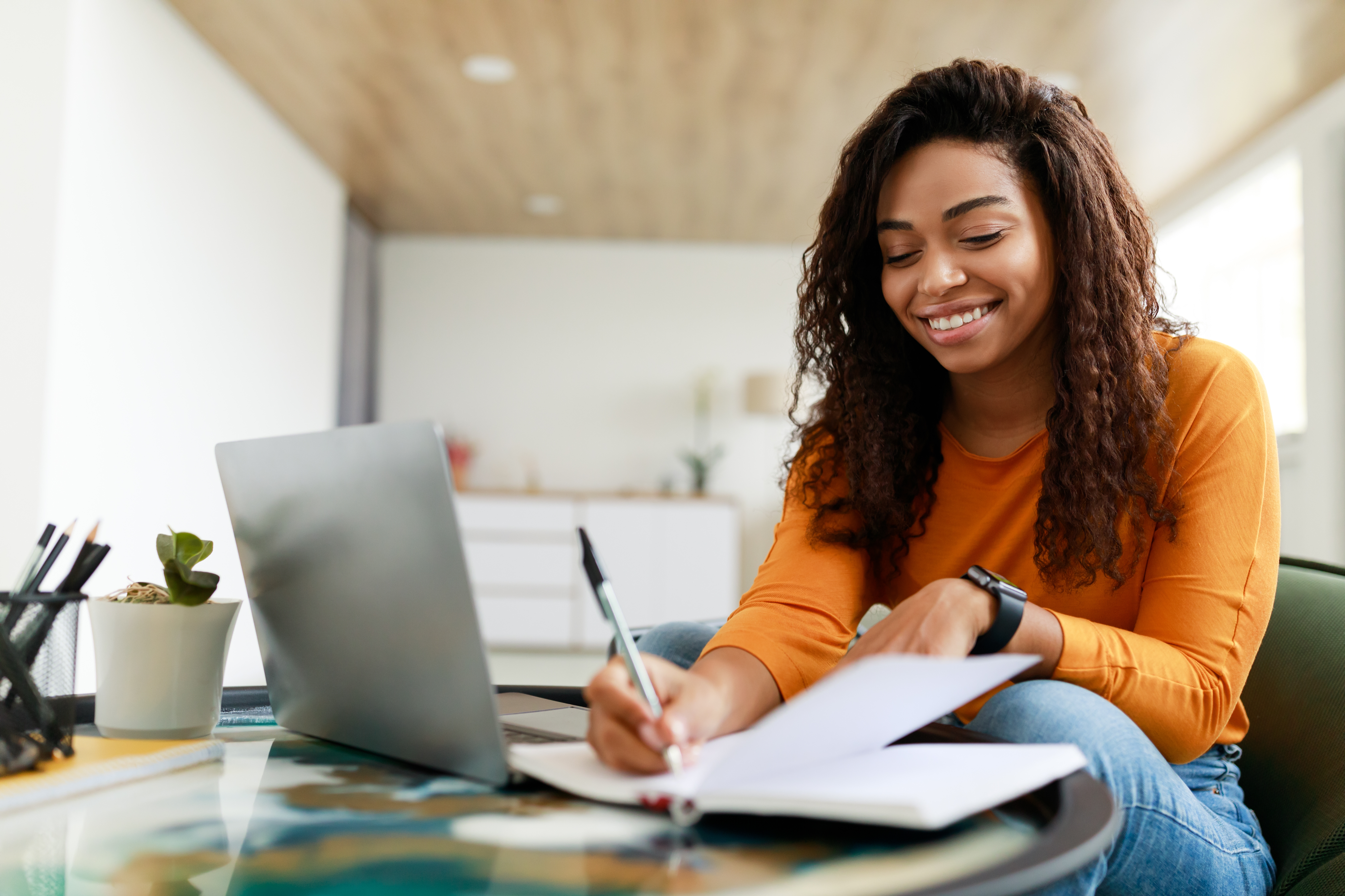 Happy University female student learning with laptop