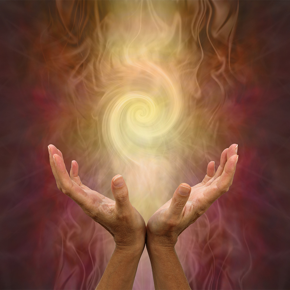 Channeling Golden Vortex healing energy - female hands held open and palms upwards with a vortex energy formation above on a warm golden brown background