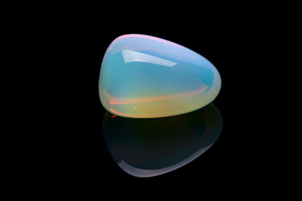 A piece of Opalite on a black background