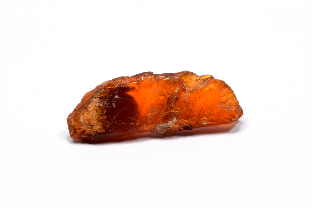 A piece of Orange Kyanite on a white background
