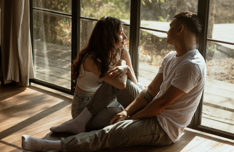 Couple sitting at window together